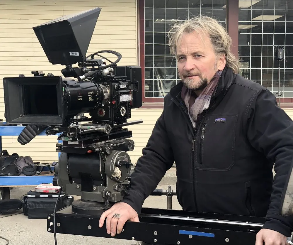 Danny Nowak on set beside a cinema camera
