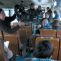 Keith Thompson operates the camera jib down the aisle of a bus.